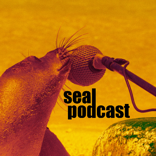 Seal talking into a microphone in an orange hue